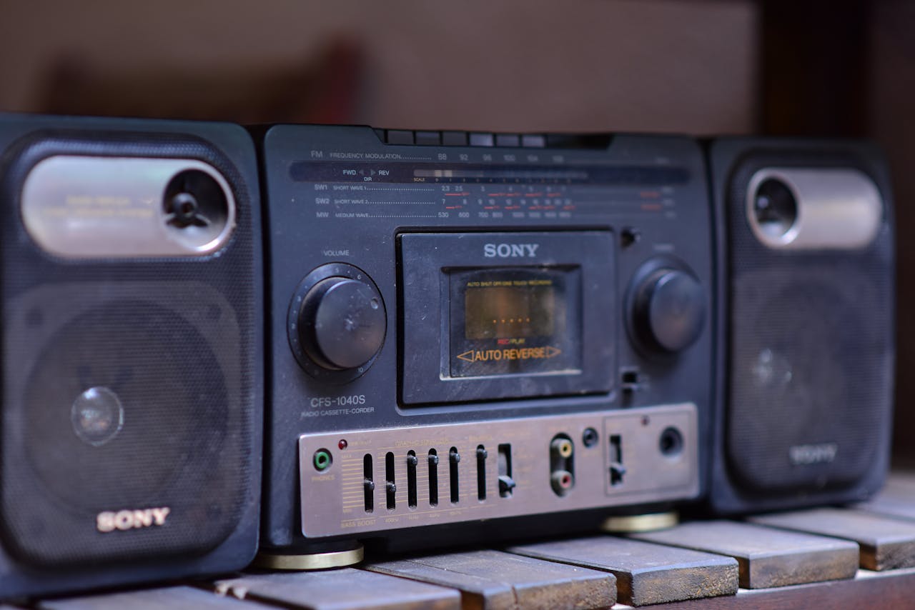 Home Close-up of a vintage Sony boombox cassette player with speakers on a wooden surface.