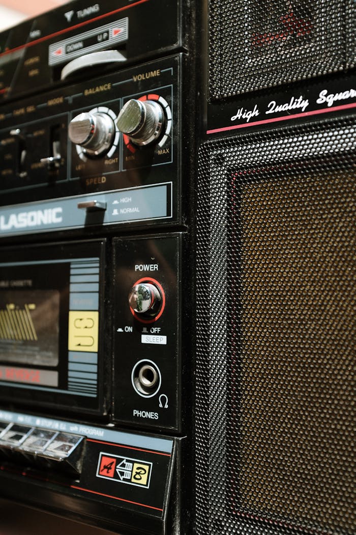 Home Vintage boombox showcasing classic design with close-up on controls and speaker.